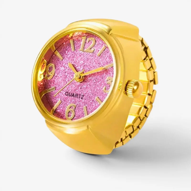 Finger ring watch with gold-toned band and sparkling pink glitter face with gold numerals