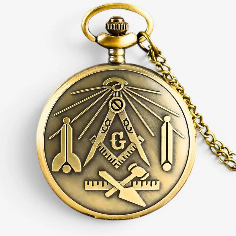 Antique brass-colored free mason pocket watch with detailed masonic emblem engraved on face and matching chain
