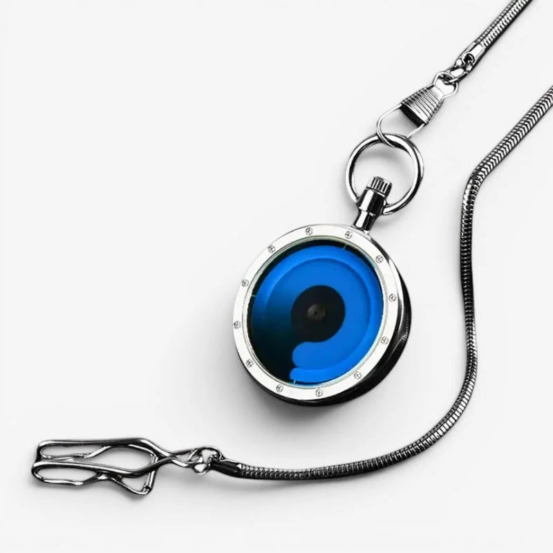 Silver-toned futuristic pocket watch with vibrant blue face, concentric rings, crystal bezel accents, and matching snake chain