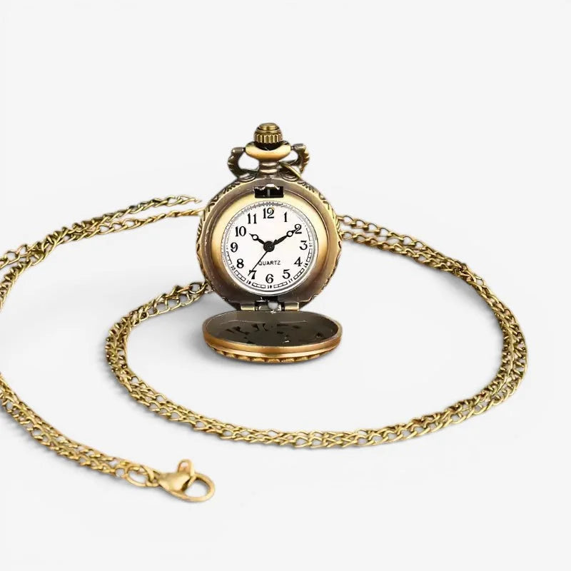 Antique gold-toned pocket watch necklace with white face black numerals on ornate chain for stylish wear