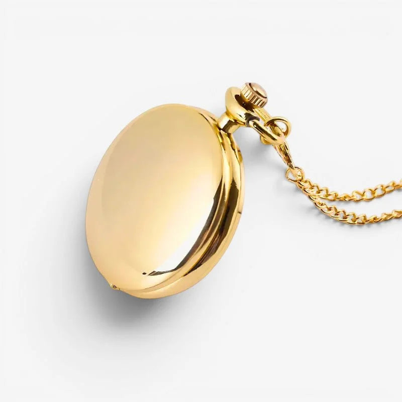 Gold pocket watch pendant with polished metallic finish and attached chain in an elegant oval shape