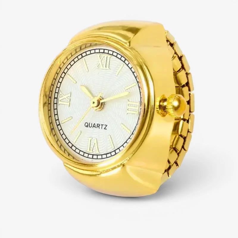 Gold roman numeral ring watch with a gold-toned band, white dial, roman numerals, and textured bezel