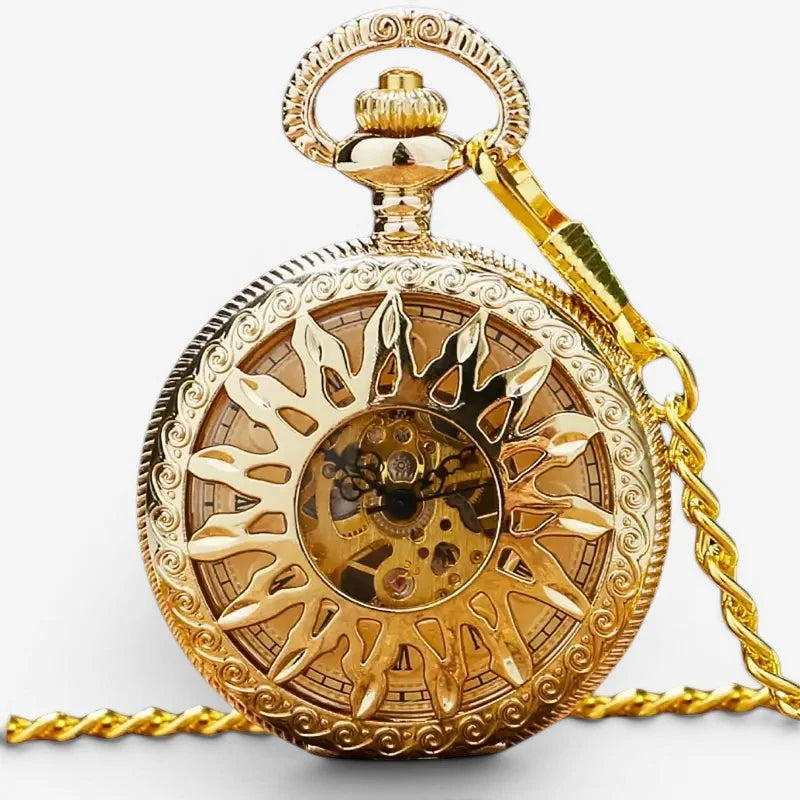 Gold sun pocket watch with intricate sunburst design, visible mechanical gears, and decorative chain for wearing