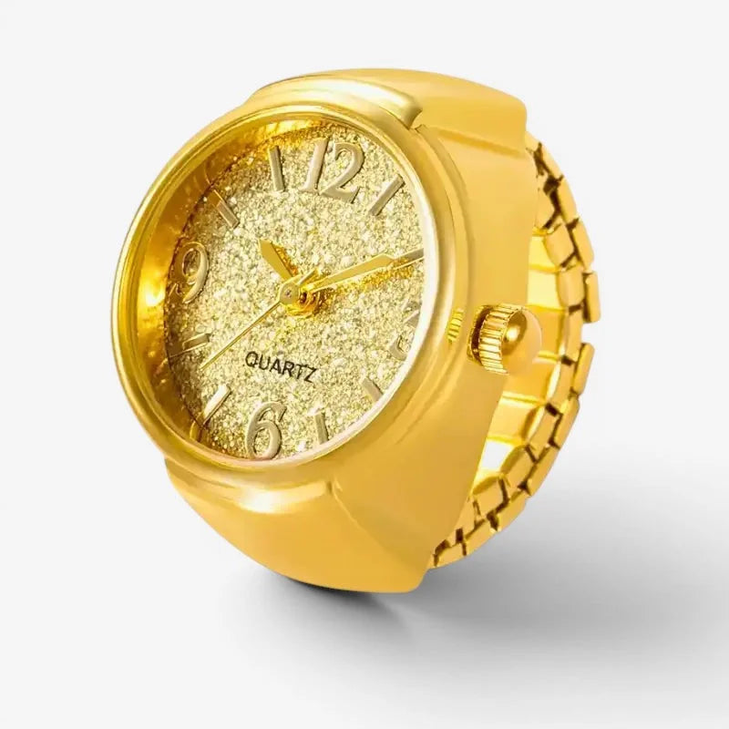 Golden quartz ring watch with a gold-colored band, sparkling glittery face, and bold metallic hour markers