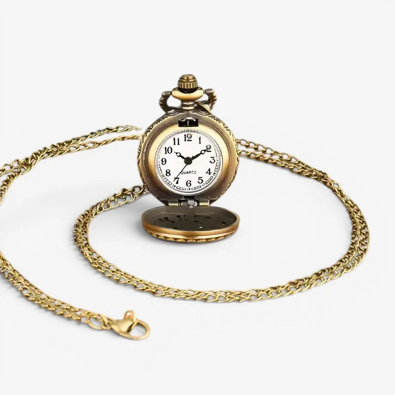 Antique brass-finished green owl pocket watch with a white dial and black numerals on an ornate gold-toned chain