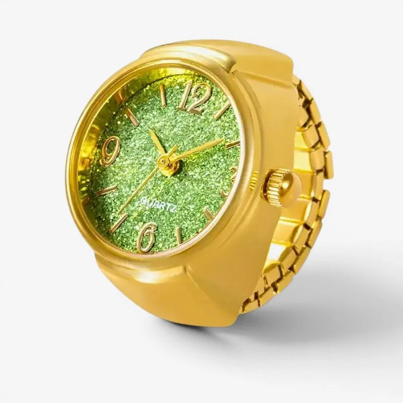 Green quartz ring watch featuring a gold-colored band and sparkling green glitter face with gold-toned hour markers