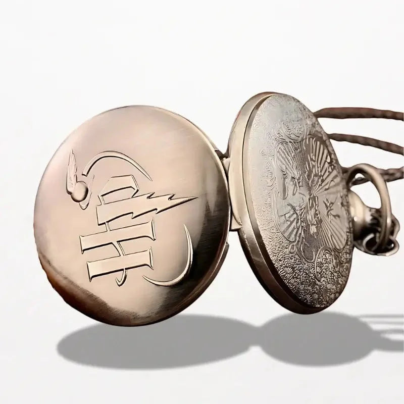 Antique bronze-colored harry potter pocket watch with intricate engraved designs and a stylized emblem on the back side