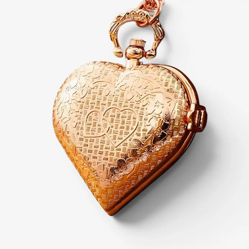 Heart pendant watch in rose gold with intricate engraved patterns and a decorative clasp in a heart shape