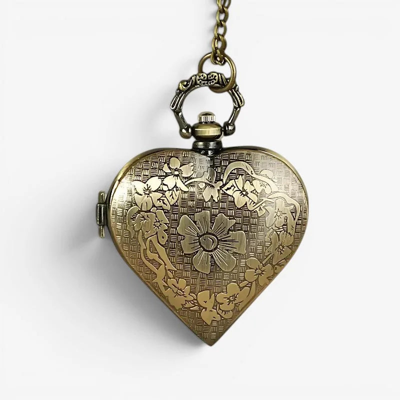 Antique brass heart pocket watch with intricate floral engravings and decorative chain for vintage style use