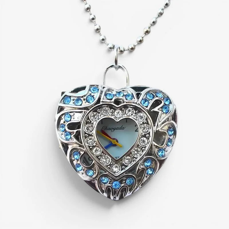 Silver heart-shaped locket watch necklace with blue and clear crystals on a delicate ball chain