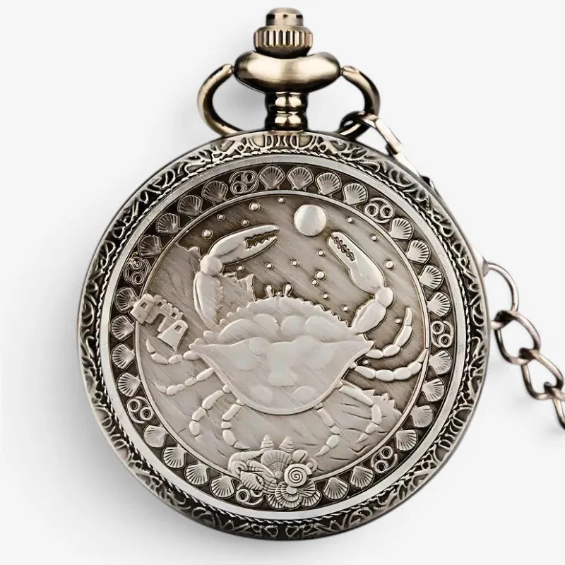 Antique silver-toned horoscope pocket watch with intricate crab zodiac design and ornate shell-patterned border
