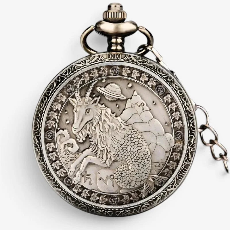 Antique-style silver horoscope pocket watch with intricately engraved goat-headed fish-tailed creature and stars background