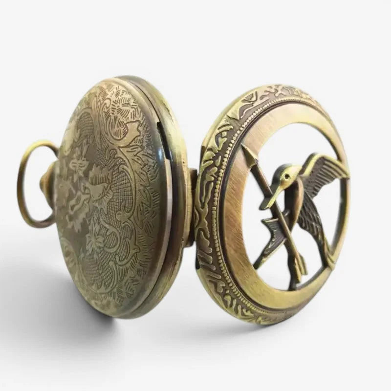 Antique brass hunger games pocket watch with engraved dragon and cut-out hummingbird emblem on backside