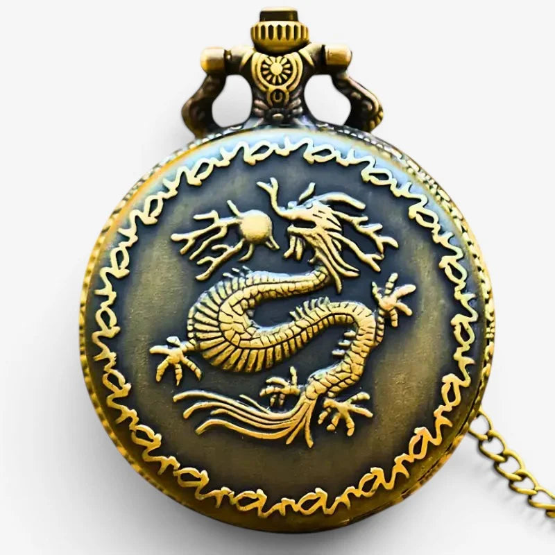 Antique brass Japanese dragon pocket watch with detailed golden dragon on darkened face and ornate chain and clasp