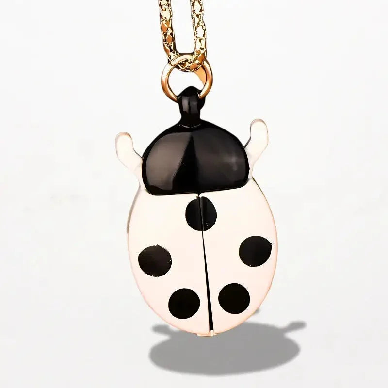 Ladybug nurse watch pendant shaped like a glossy black and white ladybug with five black spots on a gold-toned chain