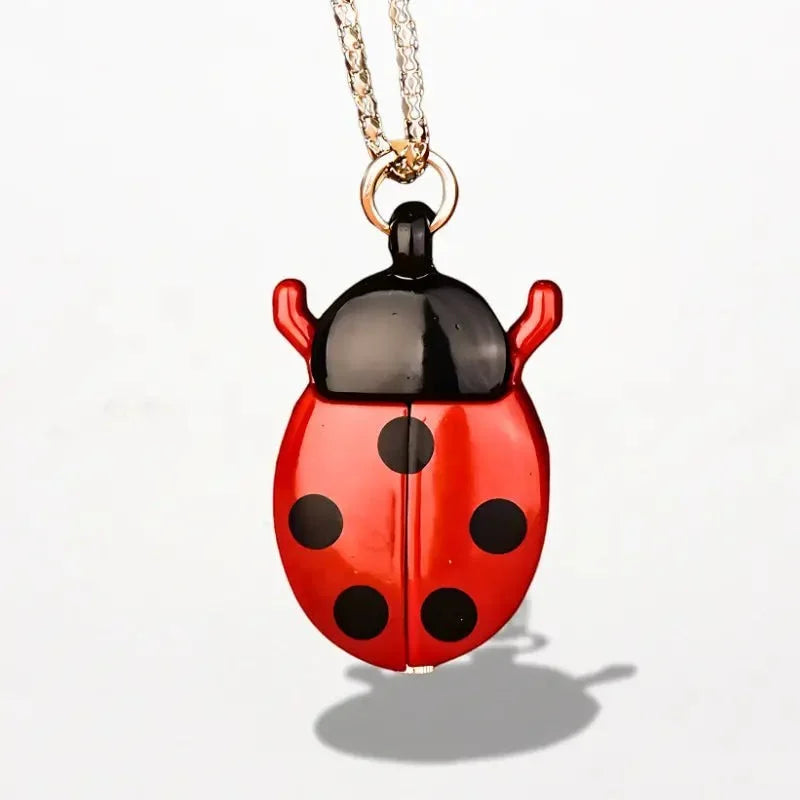 Red and black ladybug nurse watch pendant with glossy enamel finish hanging from a silver chain