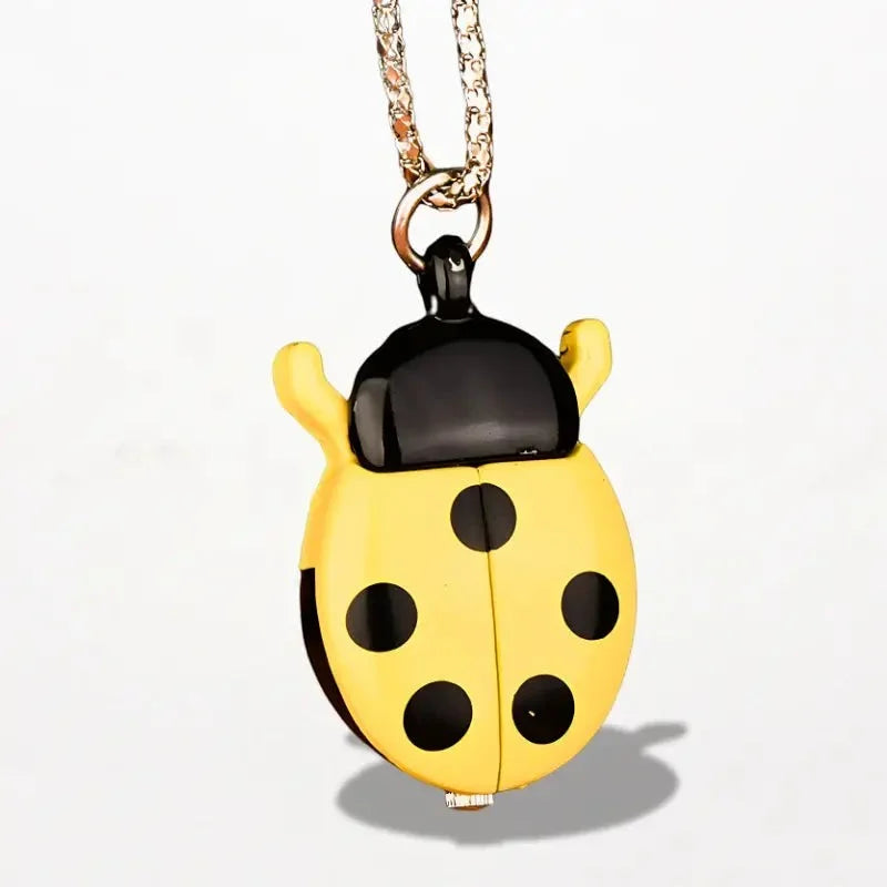 Ladybug nurse watch pocket watch in yellow and black enamel with a glossy finish hanging from gold-toned chain