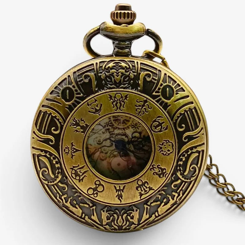 Large antique pocket watch in brass with intricate engraved designs and a central decorative dial