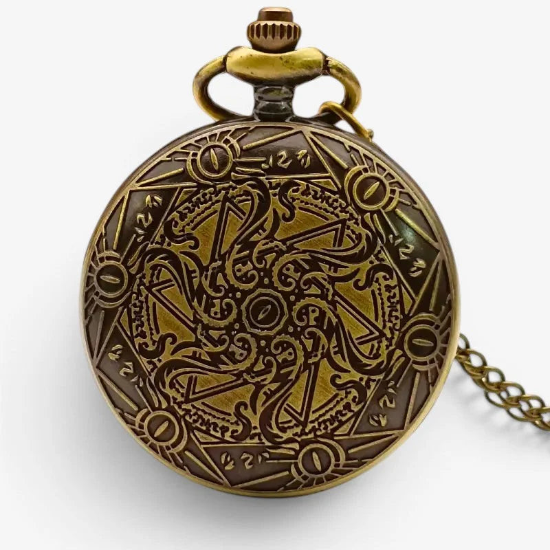 Large antique brass pocket watch with intricate dark engraved occult symbols and geometric patterns on the face