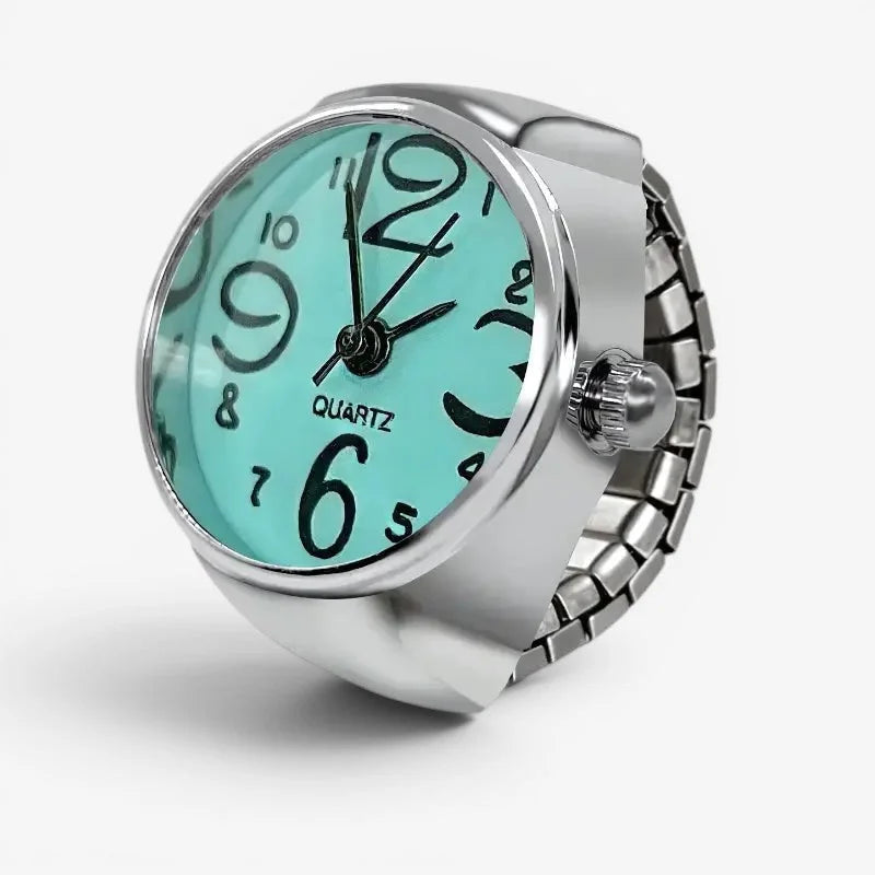 Light blue ring watch with silver-toned expandable band and mint green face with black arabic numerals