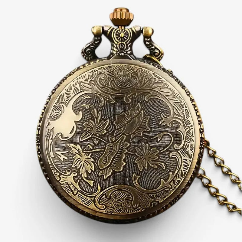Antique brass London pocket watch with intricate floral engravings and decorative crown on front side