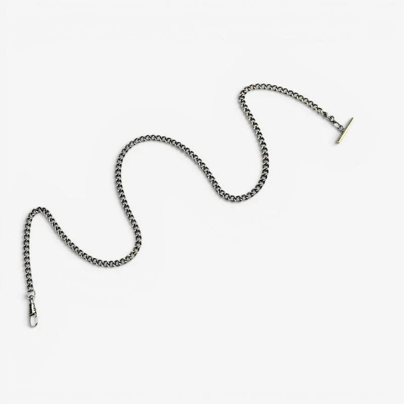 Long pocket watch chain in silver-toned metal with t-bar clasp and lobster claw hook for secure attachment