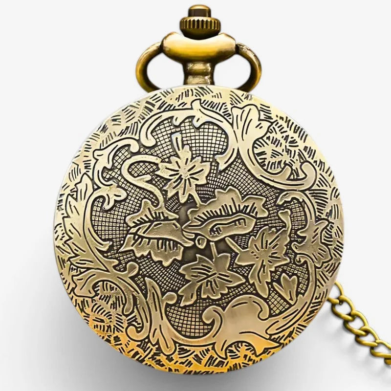 Antique brass mandala pocket watch with intricate floral vine engraving on circular face and decorative crown at top