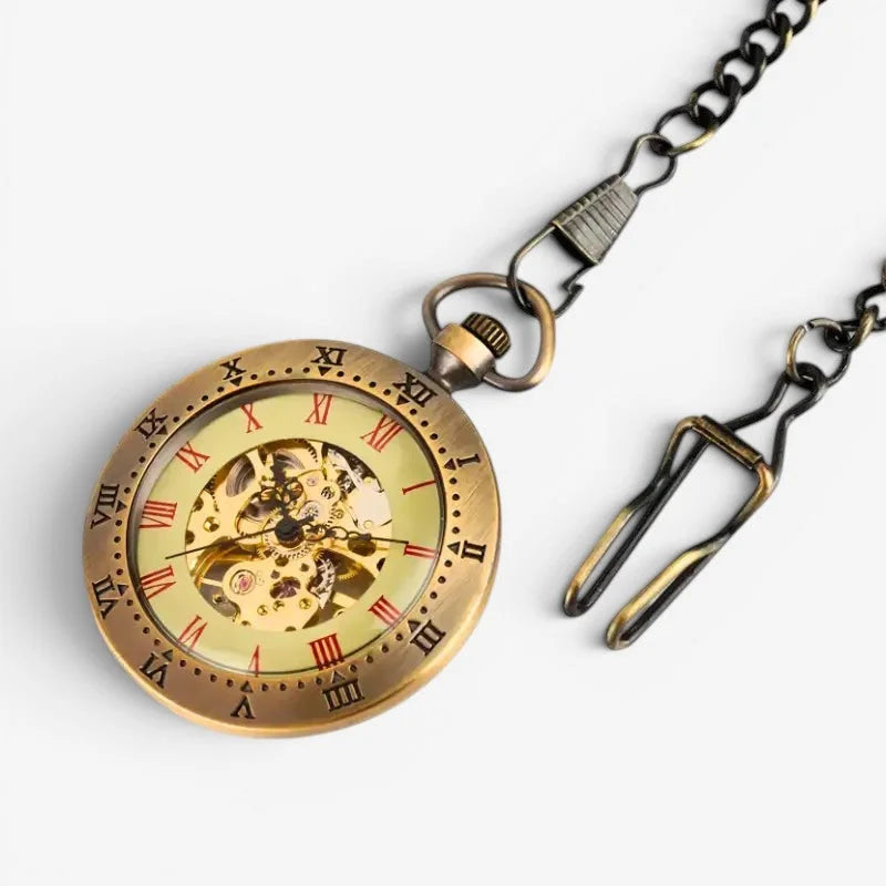 Antique brass manual pocket watch with visible mechanical gears roman numerals on light yellow face attached to dark chain
