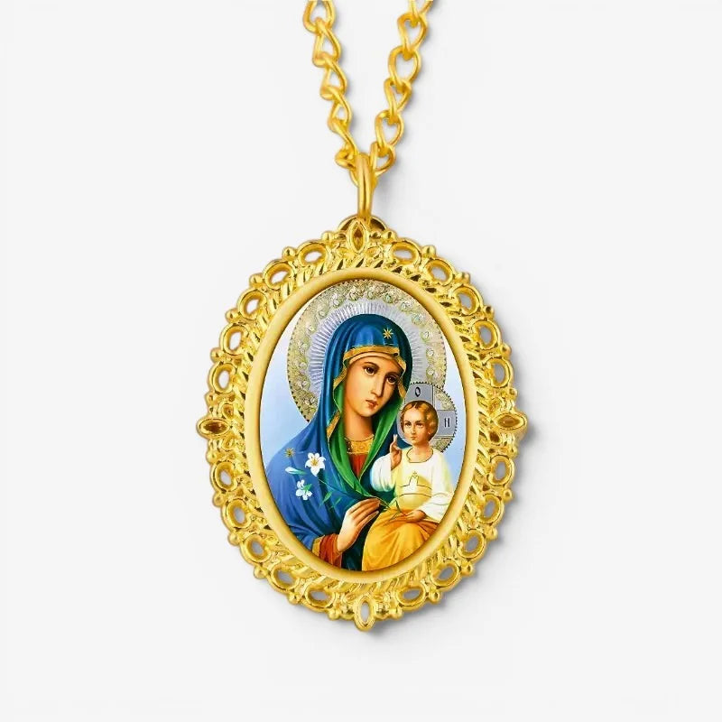 Gold-toned mary jesus pendant watch with ornate filigree frame and painted image on matching gold chain
