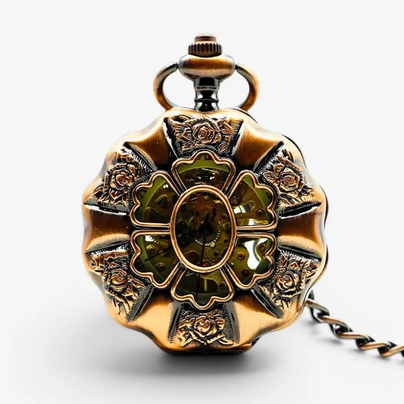 Antique brass mechanical steampunk pocket watch with intricate rose engraved floral design and green tinted gears visible