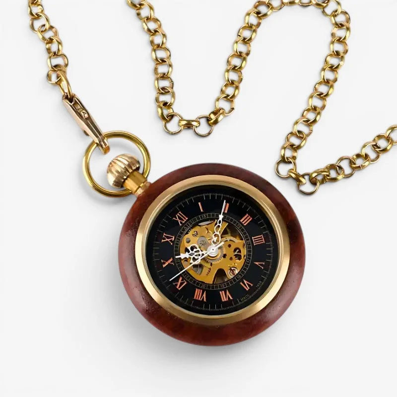 A mechanical wooden pocket watch with a polished casing gold-toned accents and roman numerals on a black face
