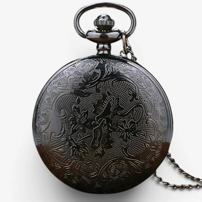 Mens antique pocket watch in black metal with intricate engraved dragon and floral patterns on its back side