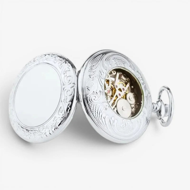 Mens mechanical pocket watch in silver with ornate engravings and visible mechanical movement on the front side