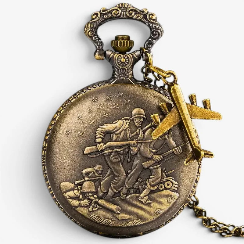 Antique brass-colored military pocket watch with intricate engraved scene and dangling airplane charm on back side
