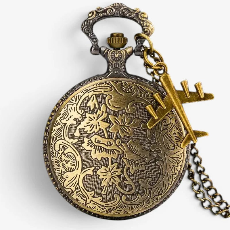 Antique brass military pocket watch with intricate floral engravings and a matching airplane charm on its chain