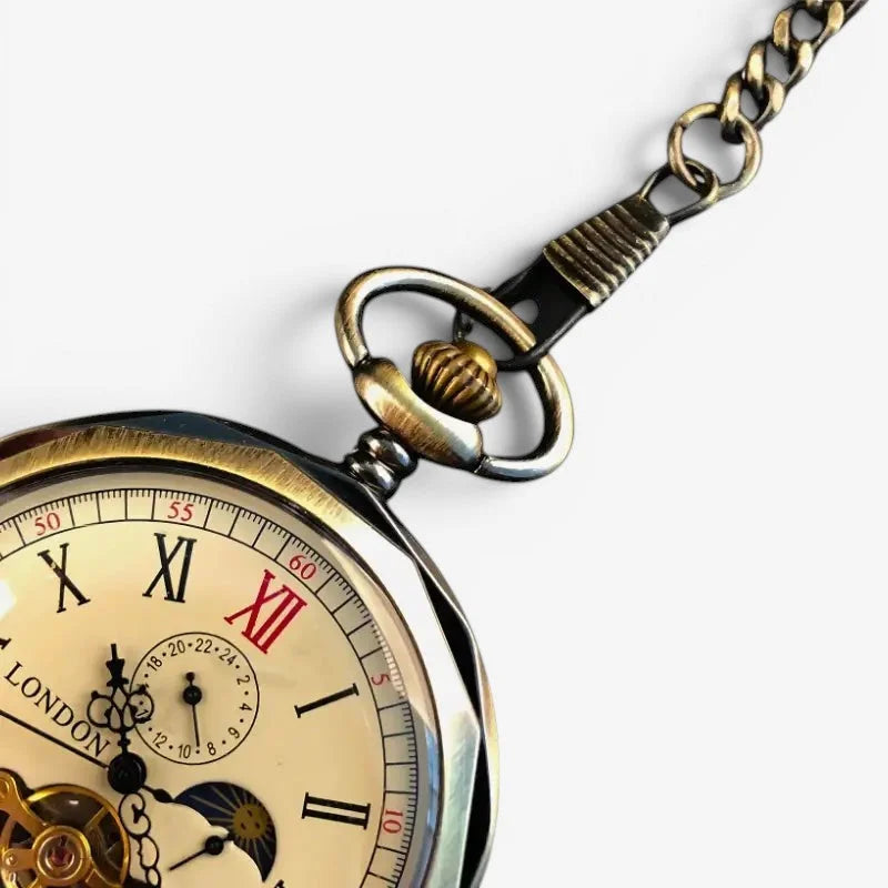 Antique-style brass moon pocket watch with cream face roman numerals in black and red and ornate chain