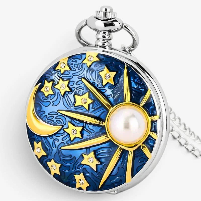 A silver-toned moon star pocket watch with a blue enamel face featuring gold stars, a crescent moon, and a central pearl sun design