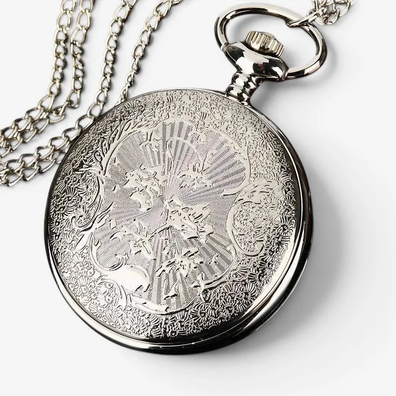 Silver-toned moon star pocket watch with intricate engraved floral scrollwork design and polished metal casing with chain