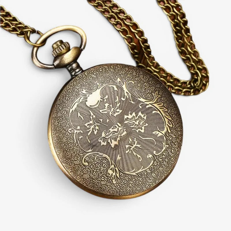 Antique brass motorcycle pocket watch with intricate floral and butterfly engravings on its circular face attached to braided chain