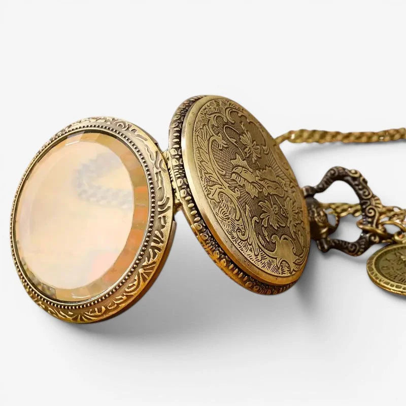 Antique gold-toned multicolor quartz pocket watch with ornate floral engraving and clear glass face on intricate chain