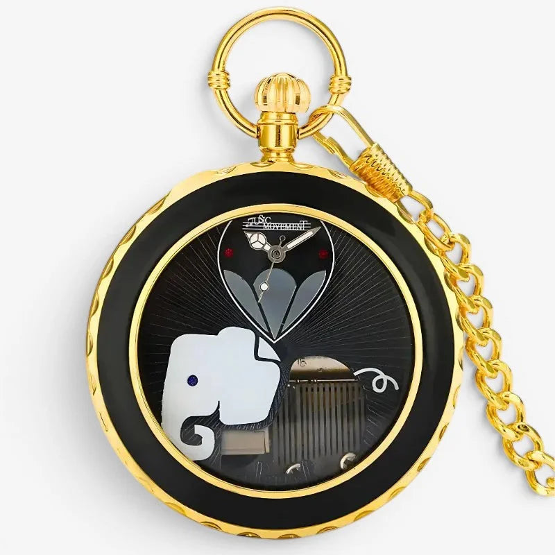 Gold-toned musical pocket watch with black dial featuring elephant and hot air balloon design in gold bezel