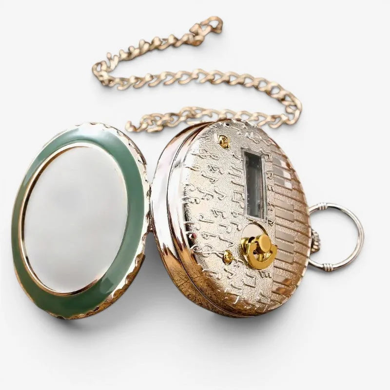 Silver and gold-toned musical pocket watch with green jade-like mirror engraved face and decorative chain