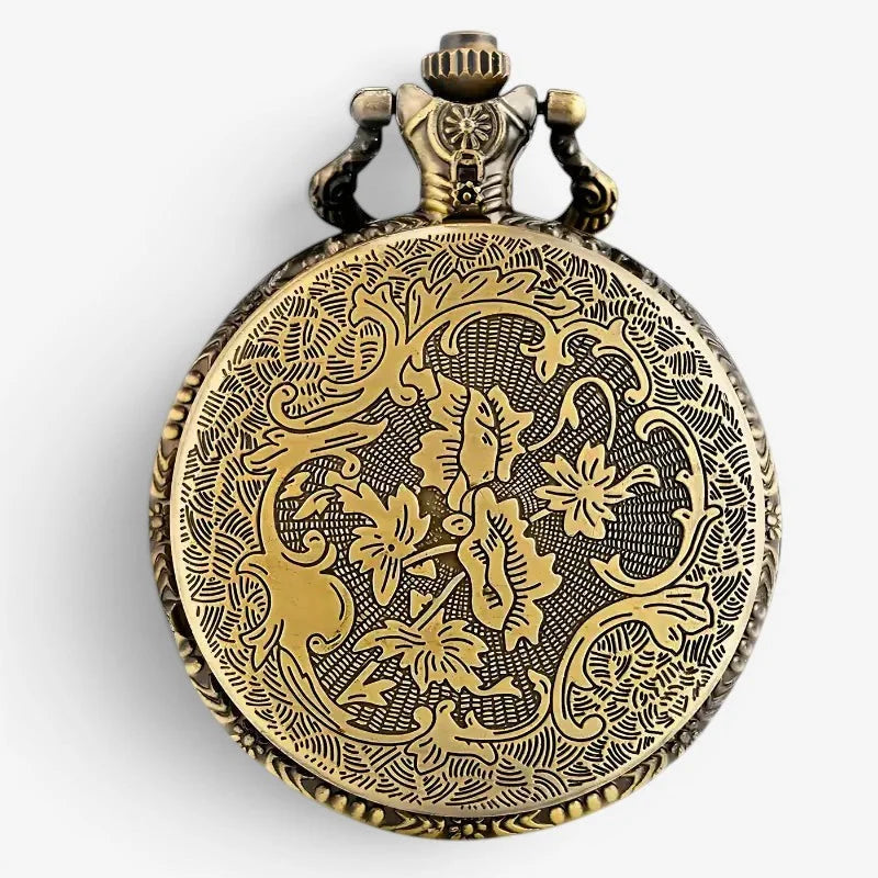 Antique-style brass napoleon pocket watch with intricate floral engravings and decorative crown detail