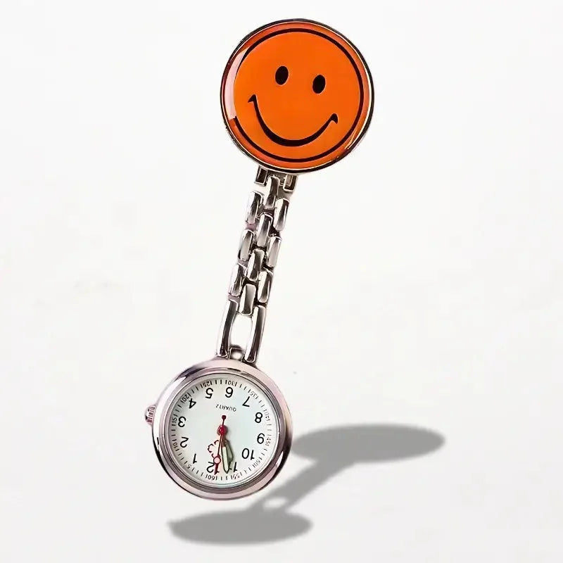 Orange smiley face pin attached to silver chain and white-faced nurse clip watch with black numerals