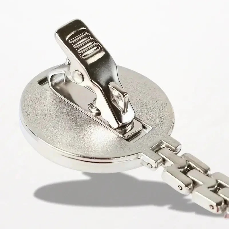 Silver-toned metal nurse clip watch with textured circular badge clip base and attached chain for secure fastening