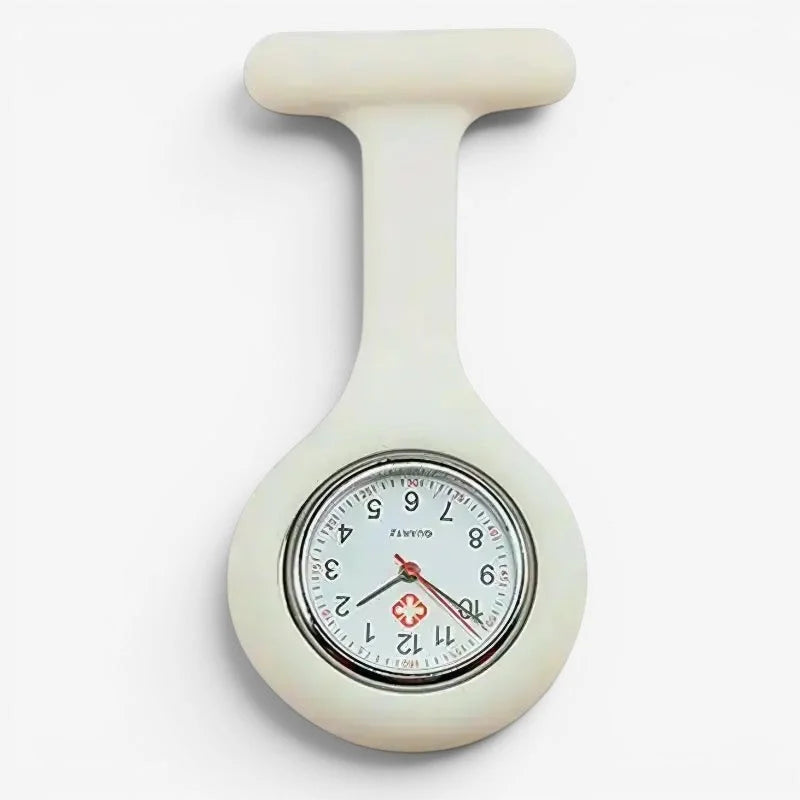 Cream-colored silicone nurse fob watch with round analog clock face black numerals red hands and red medical cross at 12 o’clock