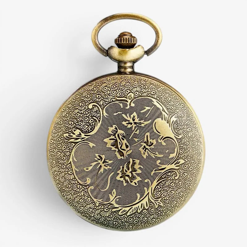 Antique brass peacock pocket watch with intricate floral engravings and a decorative winding crown