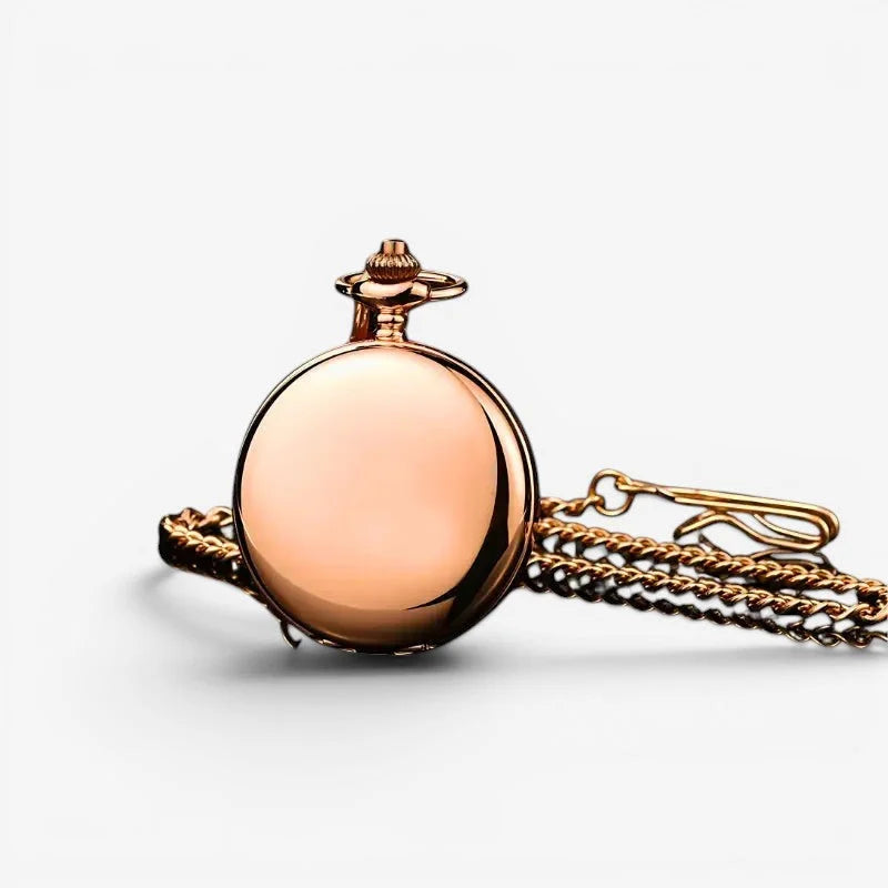 A polished rose gold mechanical pocket watch with a smooth reflective case and attached chain for stylish timekeeping
