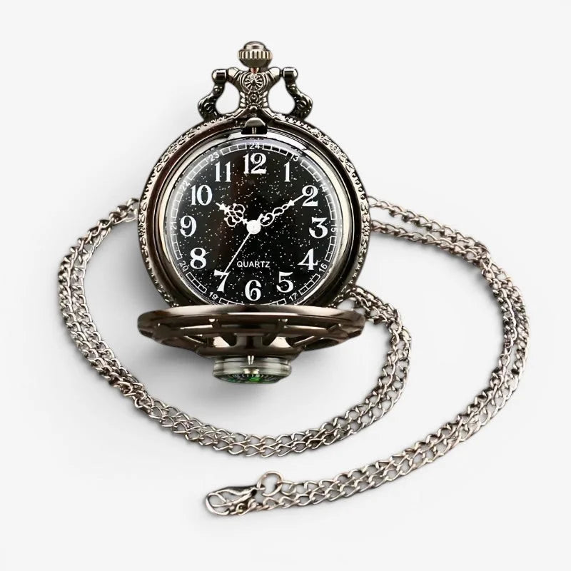 Antique-style silver-toned pocket watch compass combo with black dial, white numerals, starry background, and ornate chain