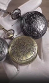 Video showcasing a collection of three ornately engraved pocket watches in silver, black, and antique brass with matching chains.
